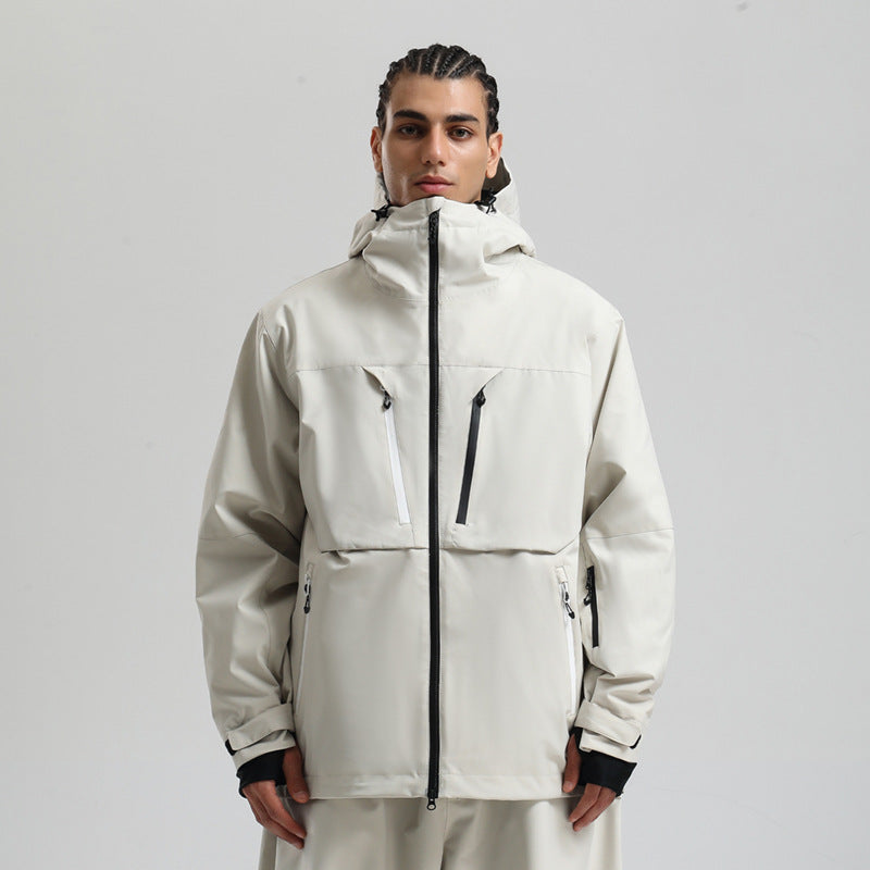 Man wearing light gray waterproof jacket with hood and black zipper details against plain background