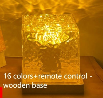 Glowing textured glass cube lamp with warm yellow light on wooden base, 16 colors plus remote control