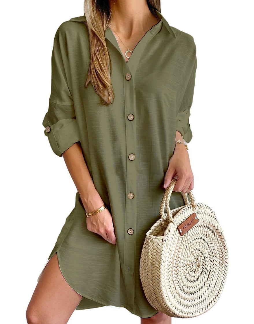 woman wearing olive green button-up shirt dress holding round woven straw handbag