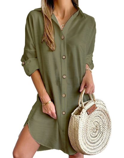 woman wearing olive green button-up shirt dress holding round woven straw handbag