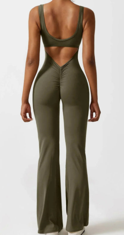 Back view of woman in olive green sleeveless cutout jumpsuit with flared legs and ruched detailing