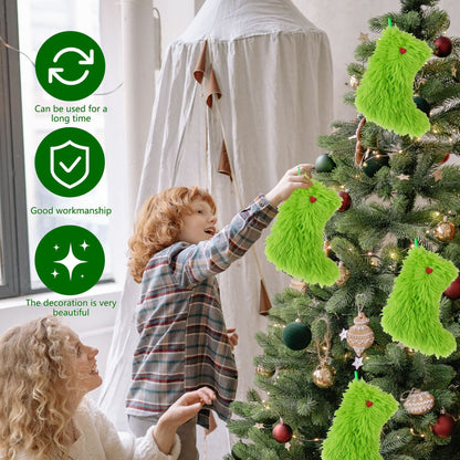 Child decorating Christmas tree with green fuzzy stocking ornaments, mother watching nearby