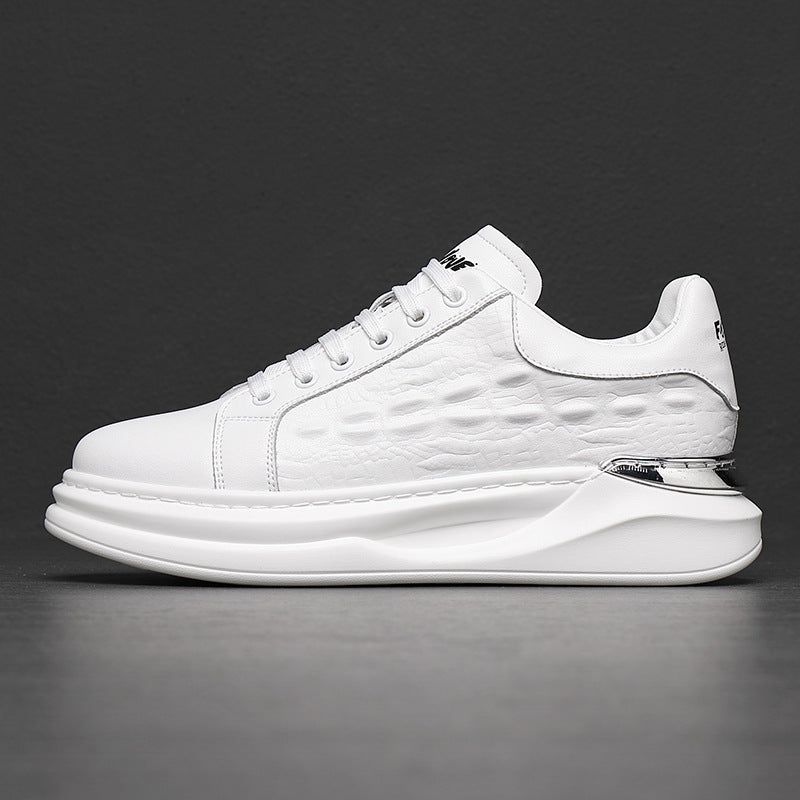Side view of white leather low-top sneaker with textured pattern and chunky sole against dark background