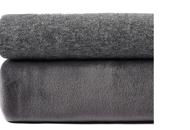 Close-up of two folded gray fabrics, one knit and one fleece, stacked on a white background