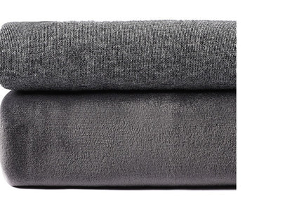 Close-up of two folded gray fabrics, one knit and one fleece, stacked on a white background