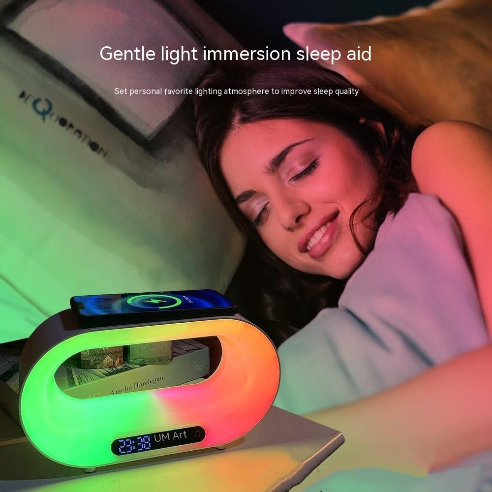 Woman sleeping next to colorful light immersion sleep aid with phone charging on top
