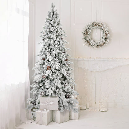 Snow-covered Christmas tree with pine cones and white wrapped gifts in bright white room with wreath