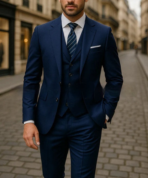 Man wearing a navy blue three-piece suit with striped tie on a cobblestone city street