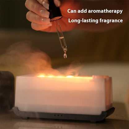 Hand adding essential oil drop into white aromatherapy diffuser emitting warm mist