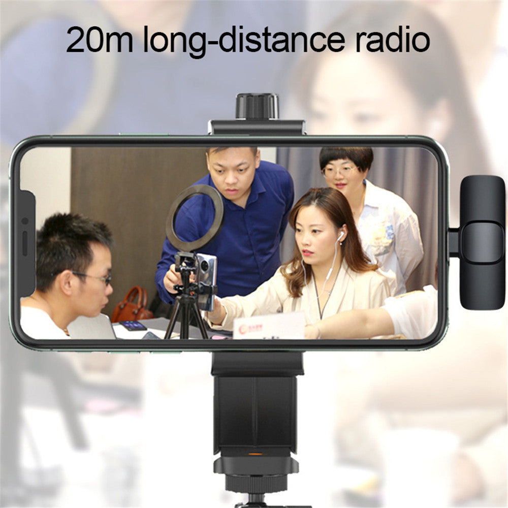 Smartphone on tripod with ring light recording four people collaborating indoors for long-distance radio