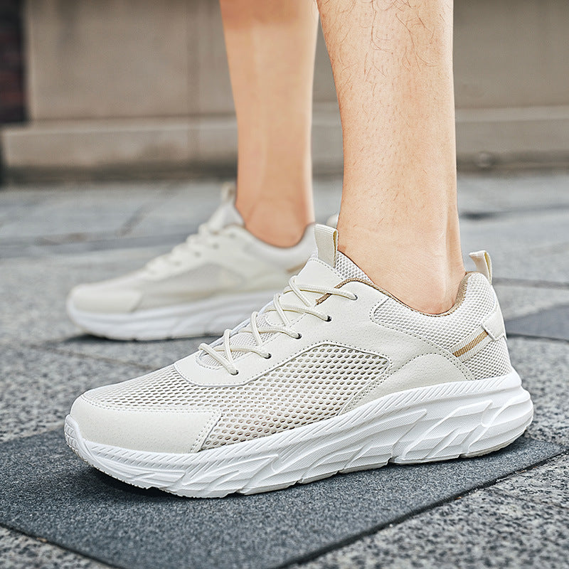 Light beige breathable mesh sneakers with white textured sole worn on pavement