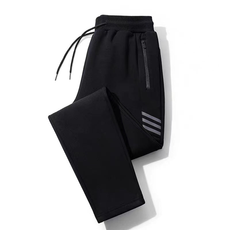 Black athletic jogger pants with elastic waistband, drawstrings, zippered pocket, and reflective stripes