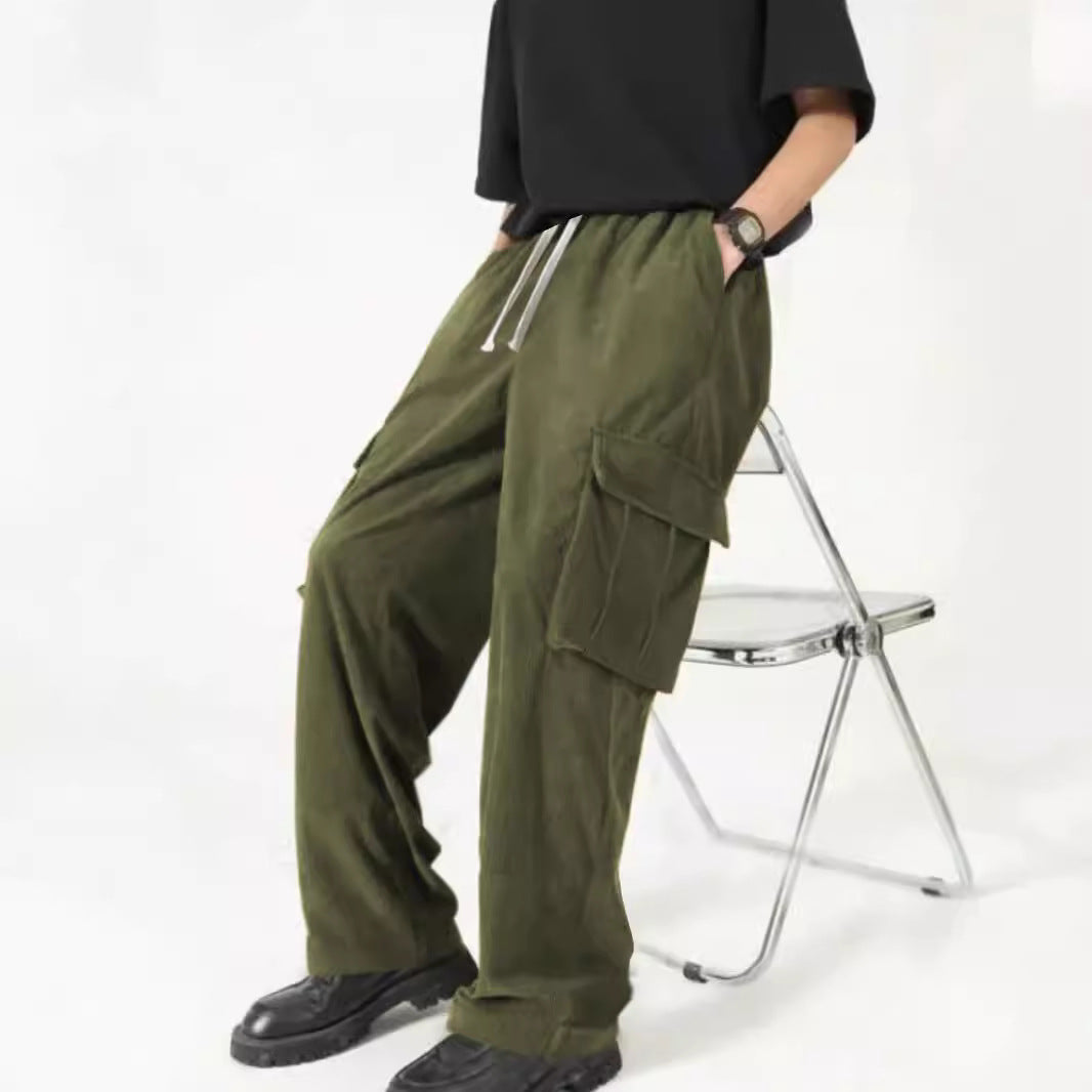 Person wearing olive green cargo pants and black shoes sitting on a metal folding chair