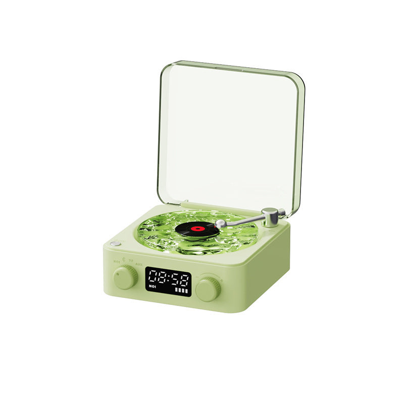 Retro green turntable with clear dust cover, playing black vinyl record, digital clock display