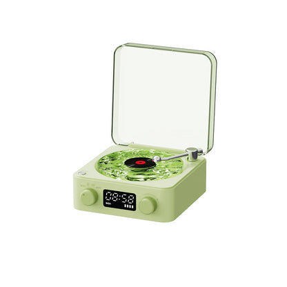Retro green turntable with clear dust cover, playing black vinyl record, digital clock display