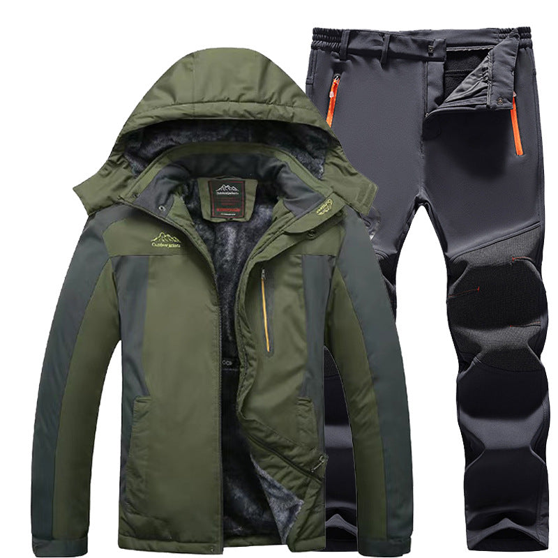 Green and black insulated winter jacket with hood and black outdoor pants with orange zipper accents