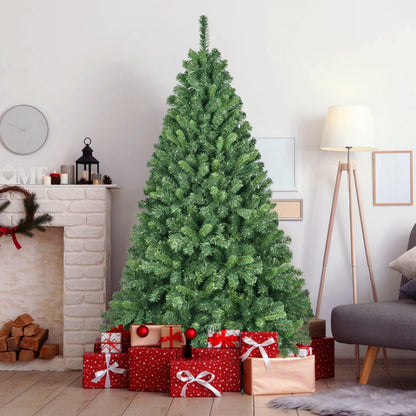 Unlit artificial Christmas tree surrounded by wrapped red and gold Christmas gifts in cozy living room