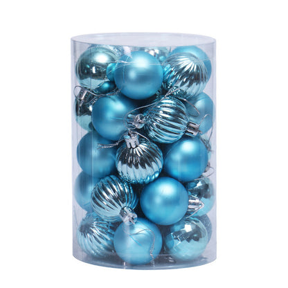 Clear cylindrical container filled with shiny and matte blue Christmas tree ornaments
