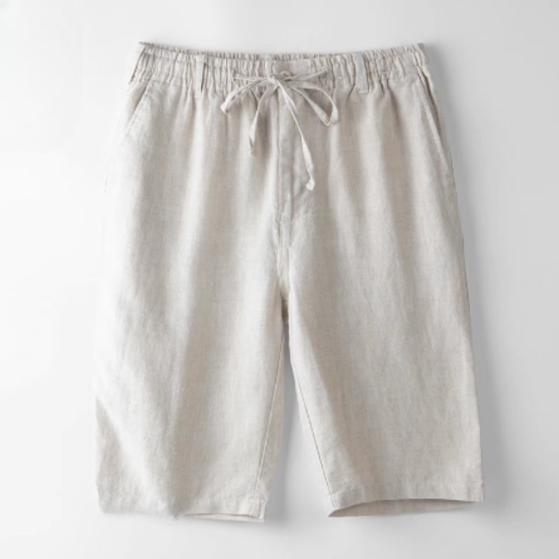 Beige casual linen shorts with elastic waistband and drawstring on white background