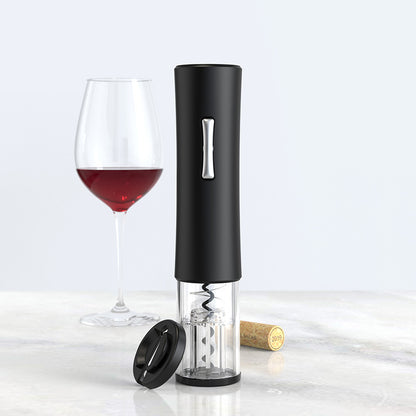 Electric wine opener with black handle, corkscrew, wine glass with red wine and cork on marble surface