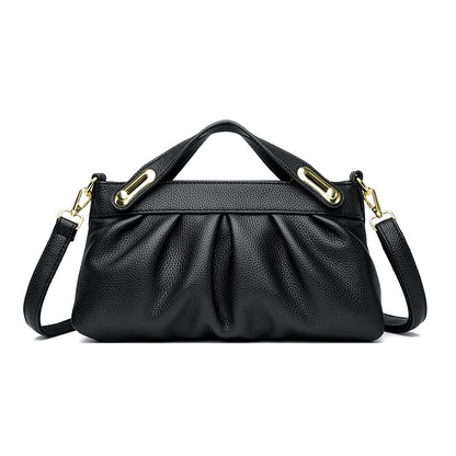 Black leather handbag with gold hardware, detachable shoulder strap, and gathered front design