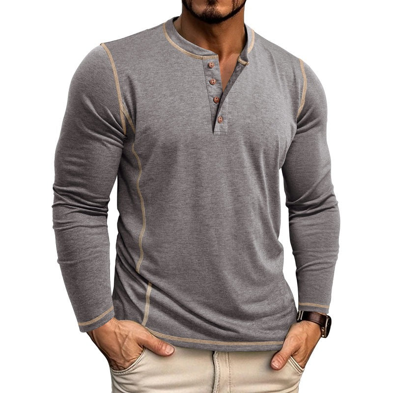 Man wearing fitted grey long-sleeve henley shirt with button placket and beige stitching, paired with beige pants