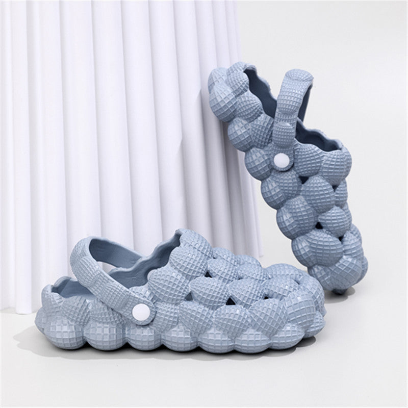 Light blue bubble-textured slip-on clogs with adjustable back strap on white surface