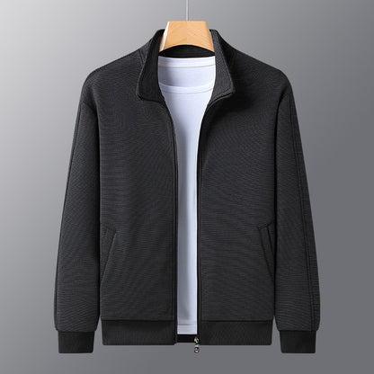 Black textured zip-up jacket on hanger over white t-shirt on gray background