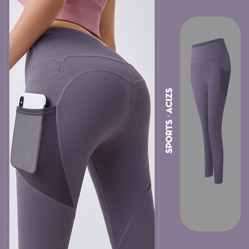 Women's purple workout leggings with high waist and side pocket holding phone, ideal for sports