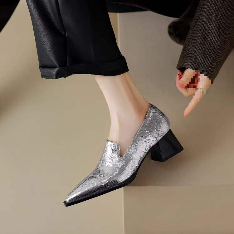 Women's silver textured leather block heel shoes with pointed toe worn with black pants