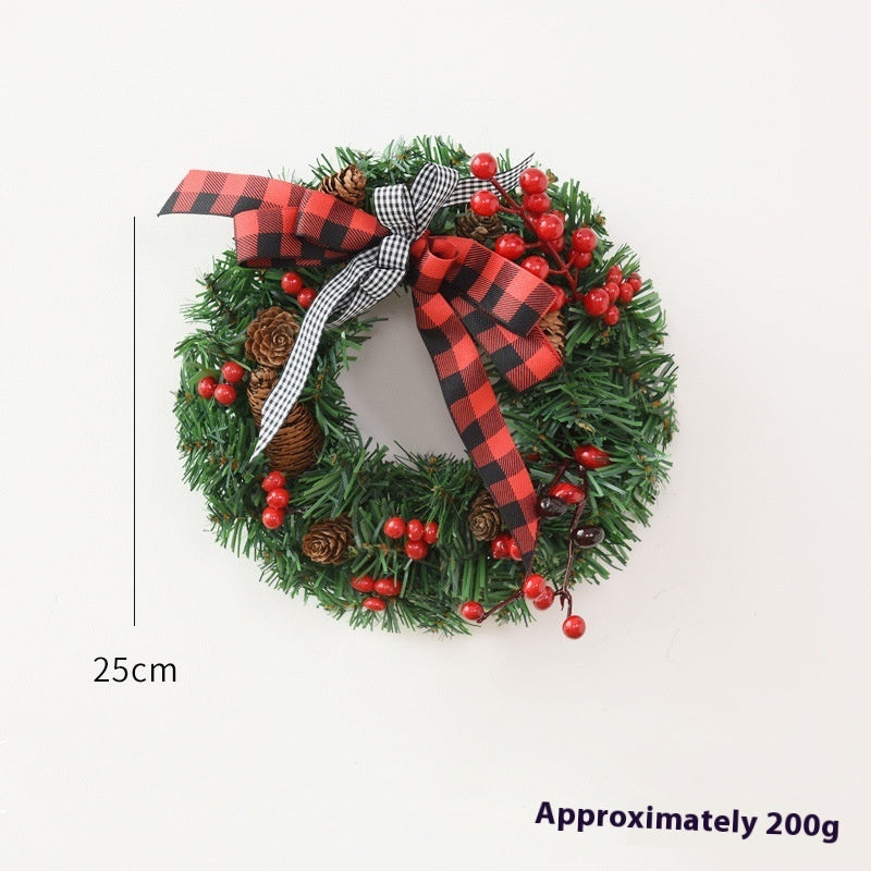 25cm Christmas wreath with pinecones, red berries, and red and black checkered ribbon bow