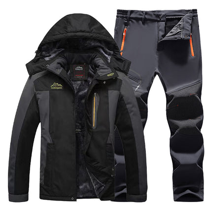 Black and gray waterproof outdoor jacket with hood and matching insulated hiking pants with orange zipper details