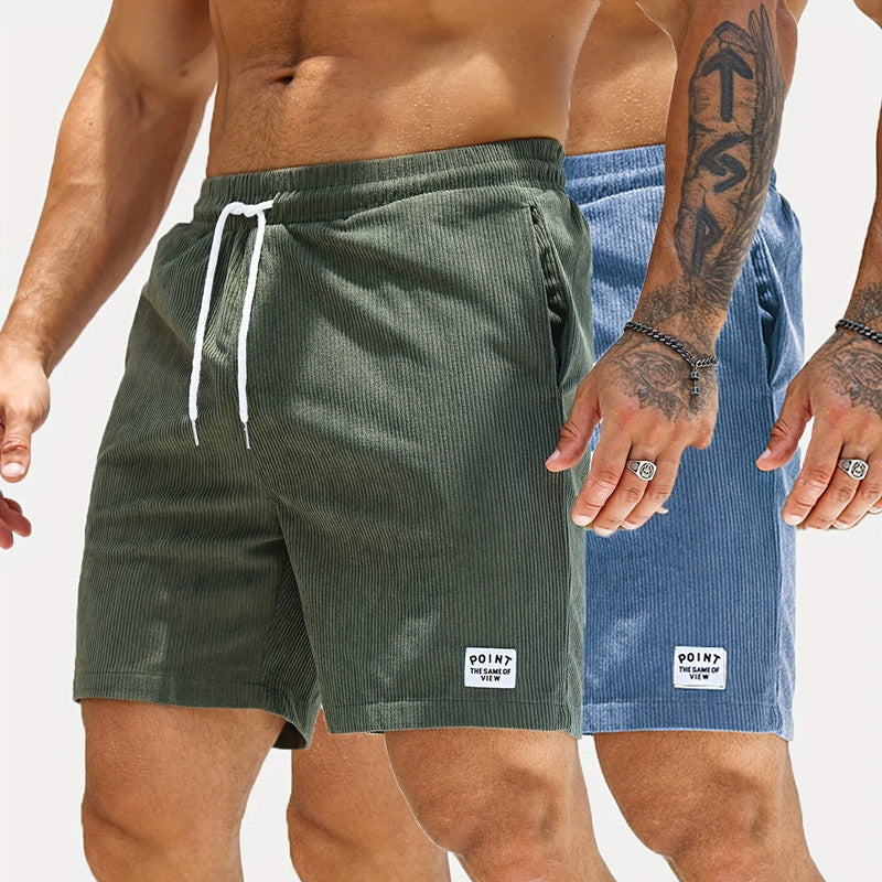 Men wearing casual corduroy shorts in green and blue with white drawstrings and patch logos