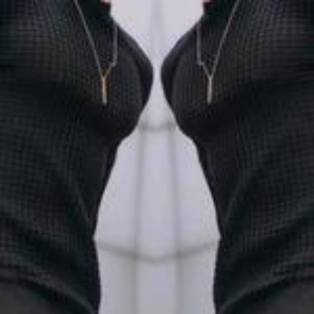 Close-up of black textured fabric with vertical zippers on both sides