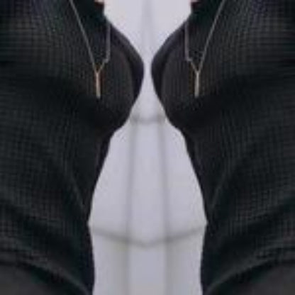 Close-up of black textured fabric with vertical zippers on both sides