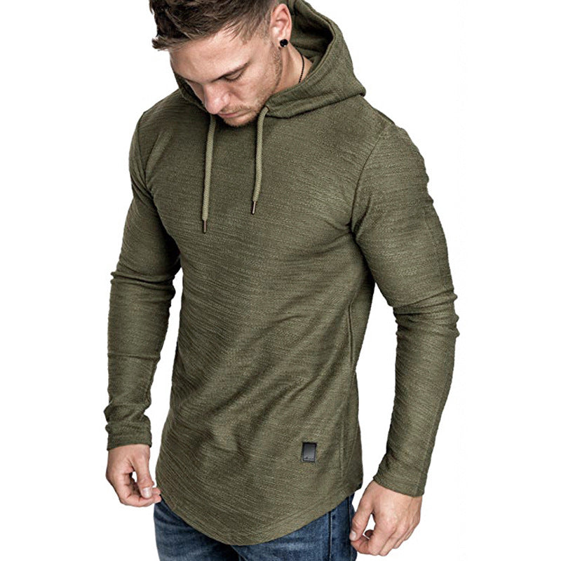 Man wearing olive green textured long-sleeve hoodie with drawstrings and curved hem