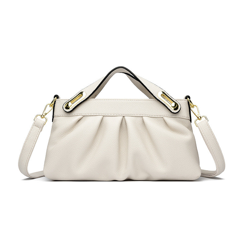 Elegant white leather handbag with pleated design, gold hardware, top handle, and detachable shoulder strap