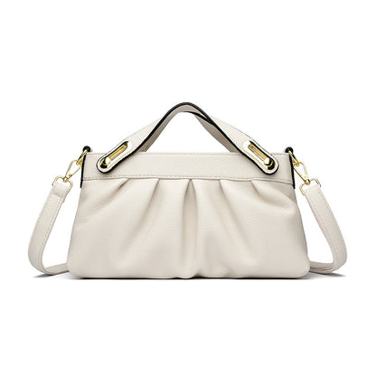 Elegant white leather handbag with pleated design, gold hardware, top handle, and detachable shoulder strap