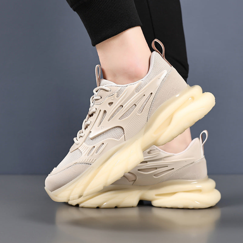 Beige sneakers with mesh and synthetic upper, thick cushioned sole, worn with black pants