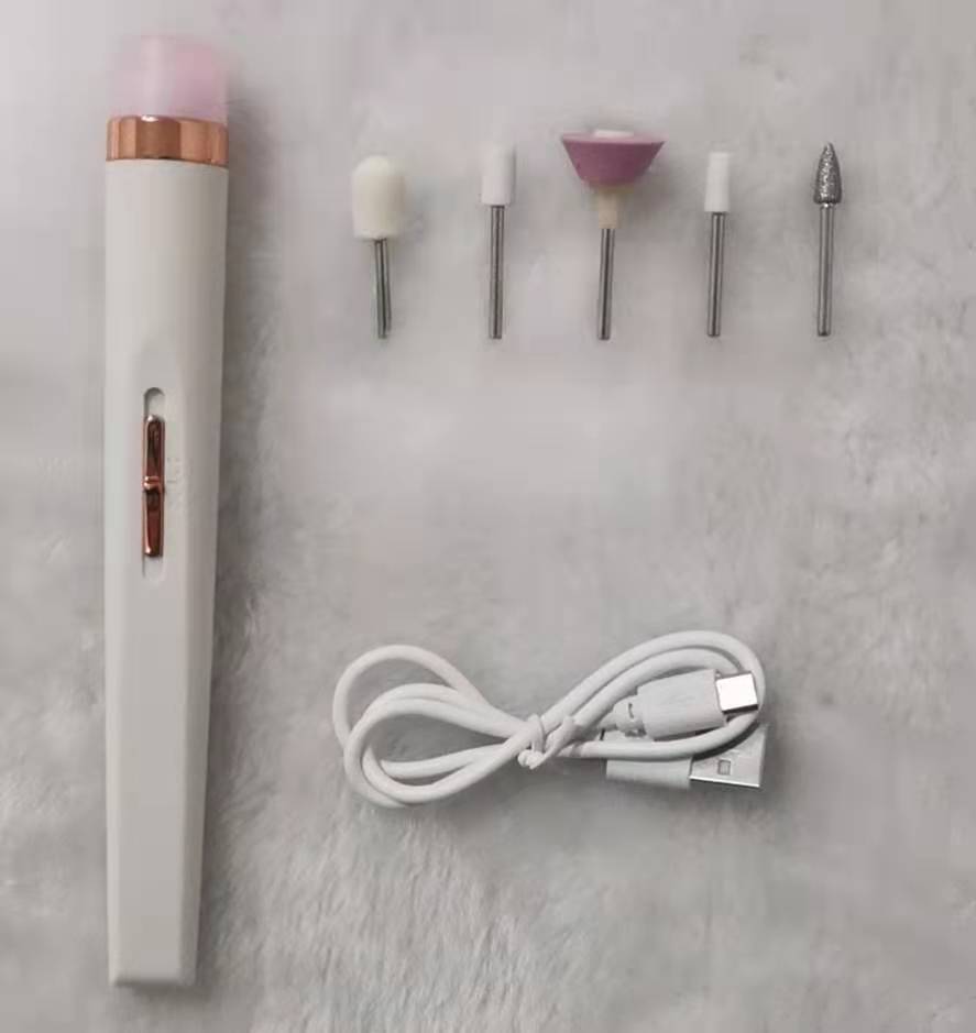 white electric nail drill pen with five polishing heads and USB charging cable on gray surface