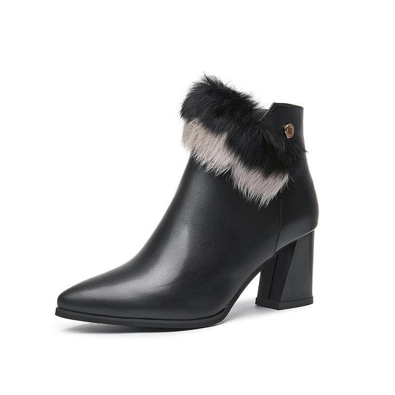 Black leather ankle boot with pointed toe, block heel, and black and gray fur trim