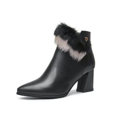 Black leather ankle boot with pointed toe, block heel, and black and gray fur trim