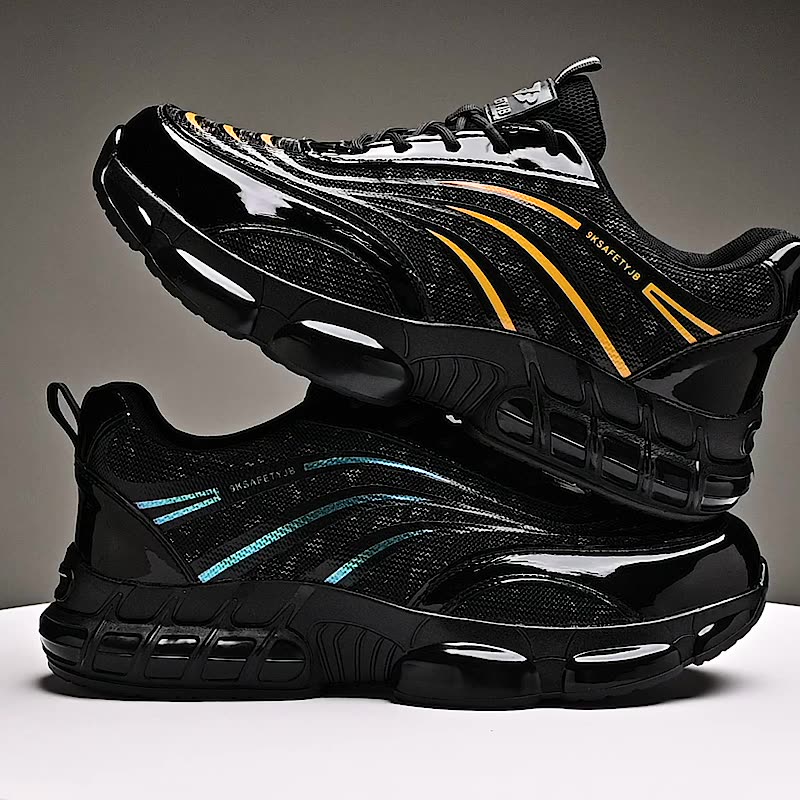 Black safety shoes with yellow and blue reflective stripes stacked on a white surface against a gray background