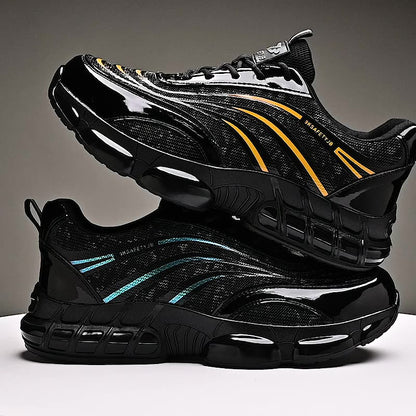 Black safety shoes with yellow and blue reflective stripes stacked on a white surface against a gray background