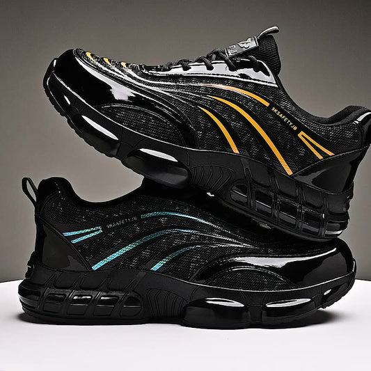 Black safety shoes with yellow and blue reflective stripes stacked on a white surface against a gray background