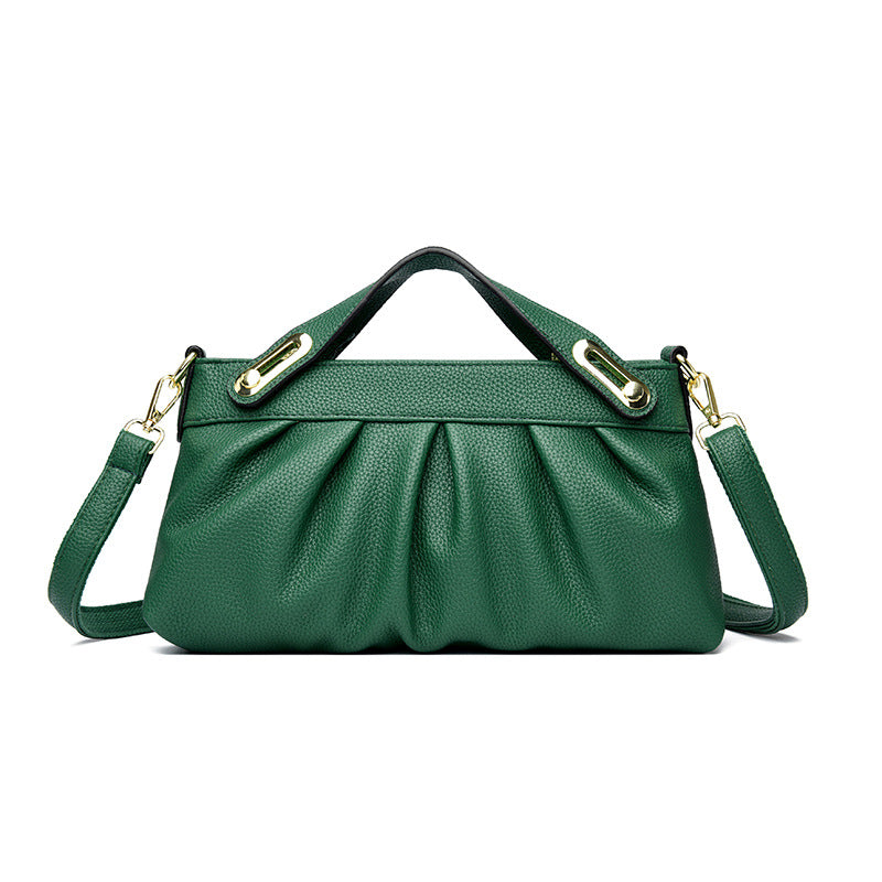 Green leather handbag with pleated design, top handle, and detachable shoulder strap with gold hardware