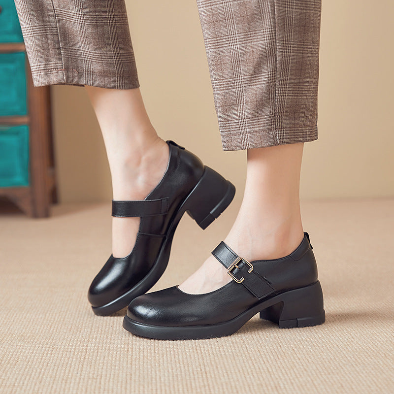 Black leather Mary Jane shoes with a low block heel worn with brown plaid pants