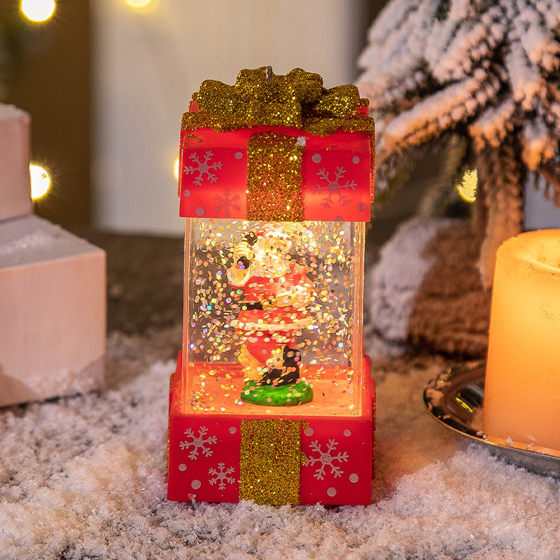 Christmas snow globe with Santa inside, decorated with red and gold glitter gift box, snowy festive setting