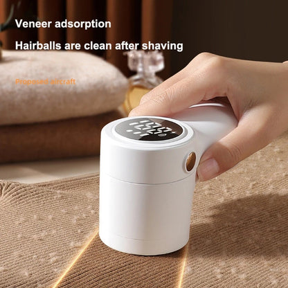 White electric fabric shaver removing lint and hairballs from brown textured cloth