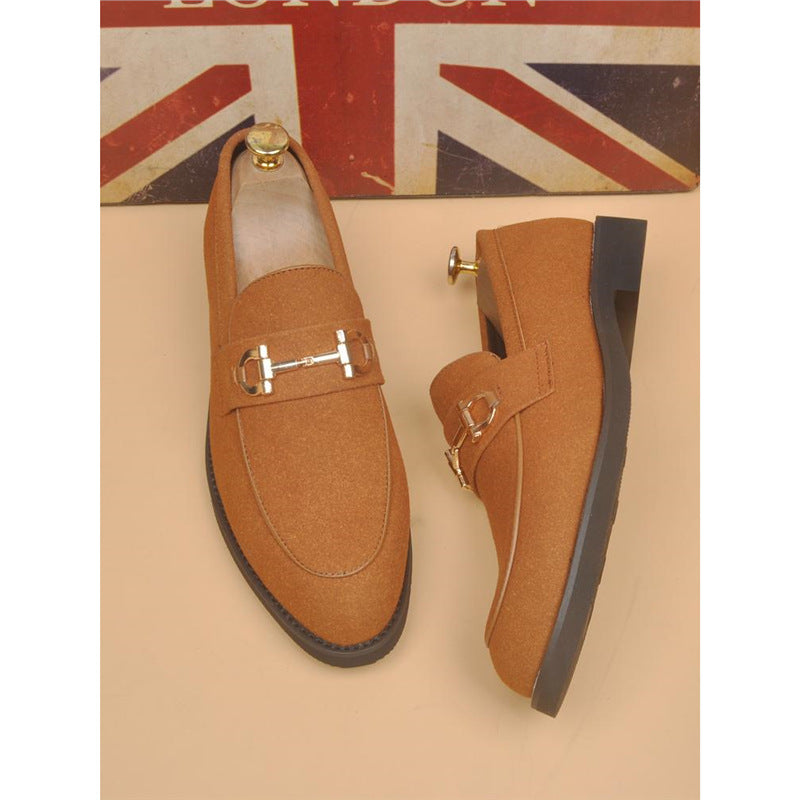 Brown suede men's loafers with gold horsebit detail and black soles, London flag backdrop
